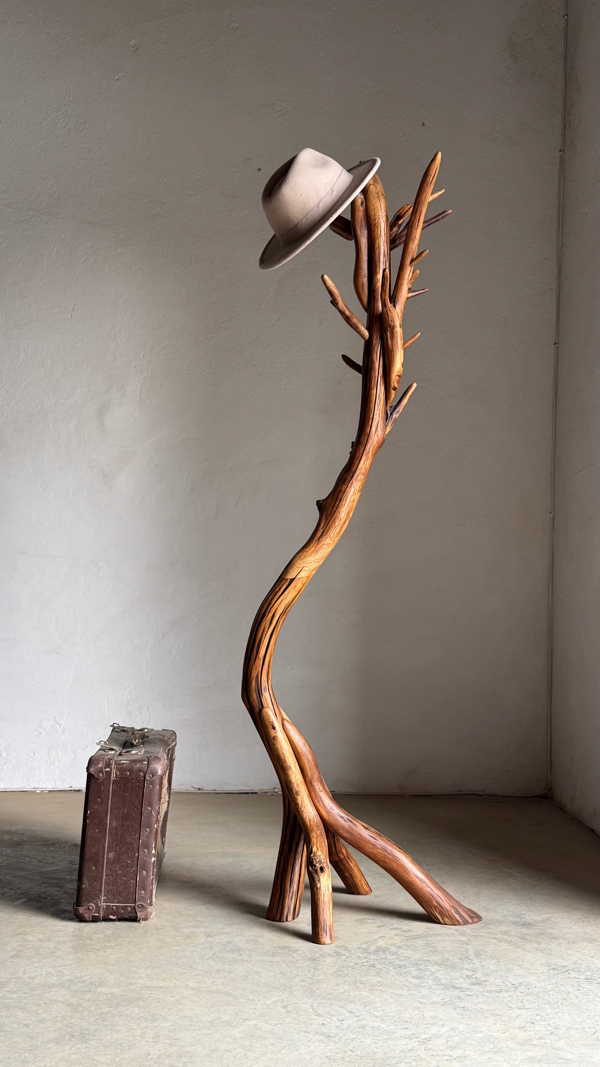 Oak Coat Rack Handcrafted Wooden coat stand with a hat on it against a plain wall.